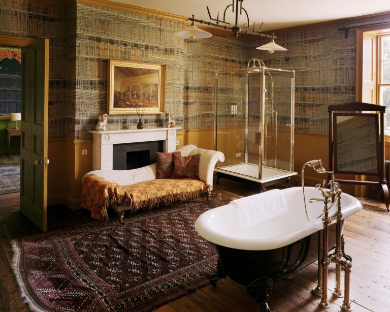 A-darkly-romantic-bathroom-with-feesanding-baths-and-persian-rug